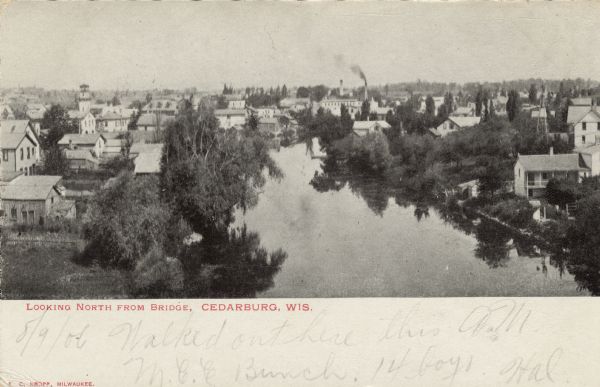 Elevated view of the Cedarburg skyline from a bridge over Cedar Creek. There are dwellings in the foreground. Caption reads: "Looking North from Bridge, Cedarburg, Wis., Cedarburg, Wis."