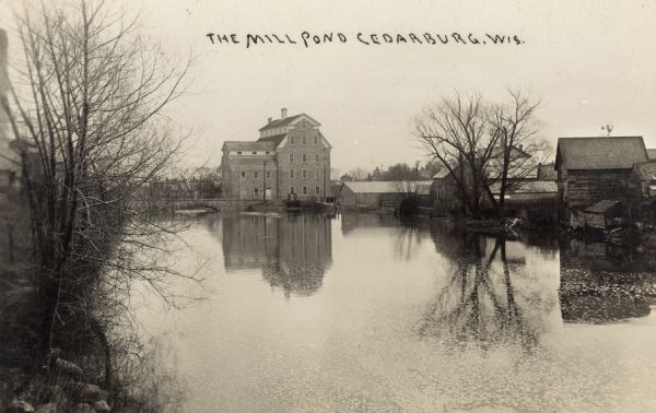 View of a mill from across the mill pond.