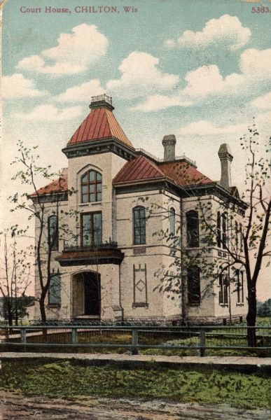 Hand-colored view of the Chilton Courthouse. A fence is along the sidewalk. Caption reads: "Court House, Chilton, Wis."