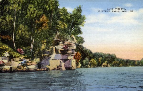 Color postcard of a view across water towards the rocky banks of Lake Wissota. Caption reads: "Lake Wissota, Chippewa Falls, Wis."