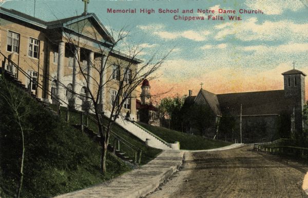 Hand-colored postcard view looking up a unpaved road and sidewalk at McDonell Memorial High School and Notre Dame church with the nuns' convent in the background. Caption reads: "Memorial High School and Notre Dame Church, Chippewa Falls, Wis."
