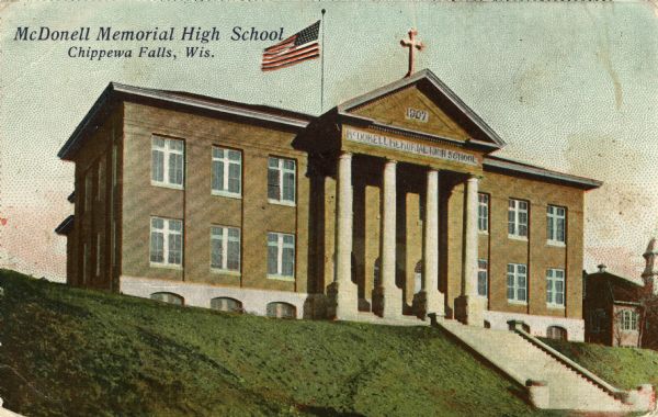 Hand-colored postcard of McDonell Memorial High School. Caption reads: "McDonell Memorial High School, Chippewa Falls, Wis."