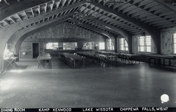 Interior view of the dining room at Kamp Kenwood, Lake Wissota. Caption reads: "Dining Room, Kamp Kenwood, Lake Wissota, Chippewa Falls, Wis."
