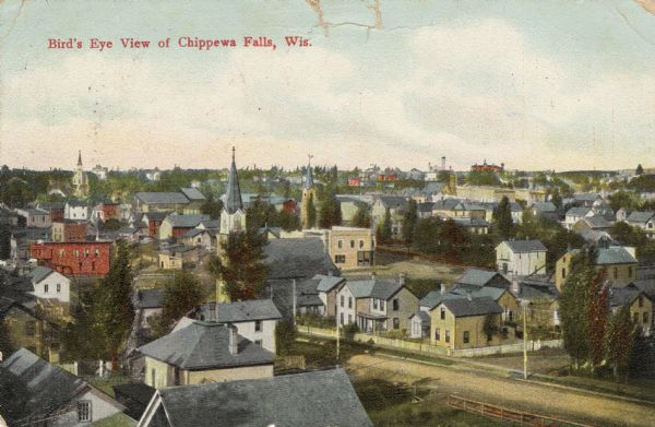 Hand-colored elevated view of houses, churches, commercial buildings, unpaved road, sidewalks and fences in central Chippewa Falls. Caption reads: "Bird's Eye View of Chippewa Falls, Wis."