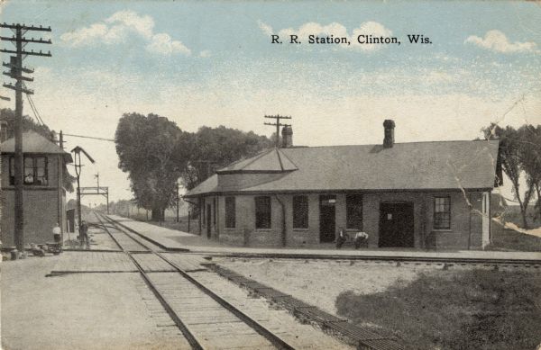 Colorized postcard view of the railroad station yard master's tower. Caption reads: "R. R. Station, Clinton, Wis."