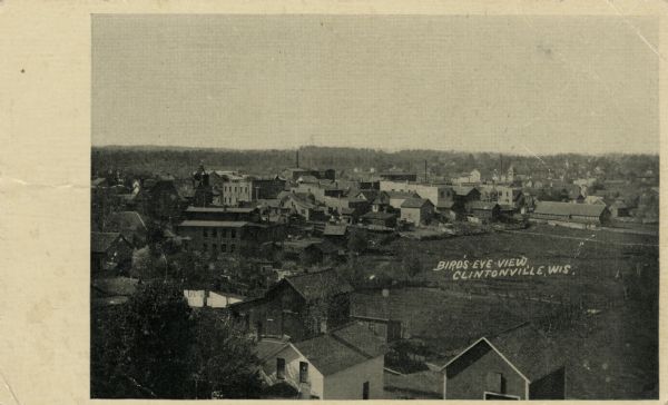 Black and white photograph of elevated view of town.