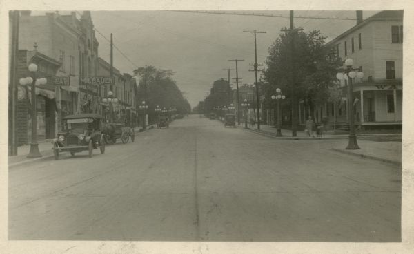 Looking down center of Main Street. Printed in the message section on the back: "A view of one of the Two-Course Reinforced Concrete Pavements in the City of Clintonville, Wisconsin, constructed by the C. Petersen Construction Co., Kenosha, Wis., under the direction of W. F. Reichardt, Consulting Municipal Engineer, Watertown, Wis. For further information address: Julius Spearbraker, City Clerk."