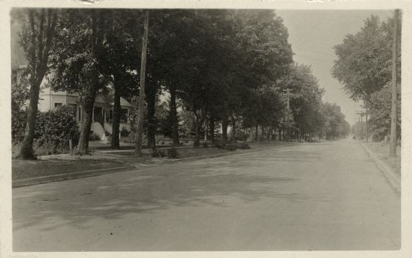 A black and white photograph of newly paved Madison Road. It was paved in 1916 with asphalt concrete by Jas. Rasmussen & Sons, Oshkosh, Wisconsin, under the direction of Col. W.F. Reichardt, Consulting Engineer, Watertown. Wisconsin.