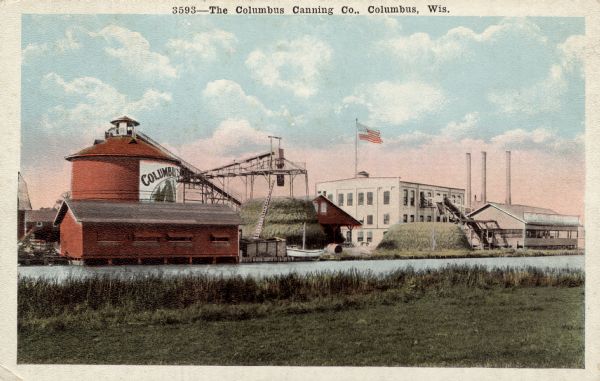 Color postcard of the Columbus Canning Company along the river. Caption reads: "The Columbus Canning Co., Columbus, Wis."