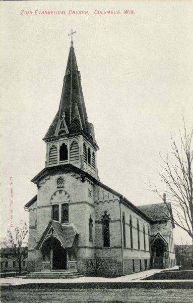 Black and white photographic postcard of the Zion Evangelical Church. Caption reads: "Zion Evangelical Church, Columbus, Wis."