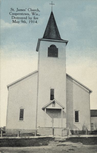 St. James Church, shown intact before being destroyed by fire May 9th, 1914. Black and white, with blue sky color added to top of card. Caption reads: "St. James Church, Cooperstown, Wis., Destroyed by fire May 9th, 1914."