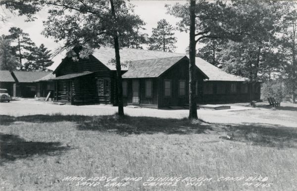Photographic postcard view of the main lodge and dining room at Camp Bird on Sand Lake. Caption reads: "Main Lodge and Dining Room, Camp Bird, Sand Lake, Crivitz, Wis."