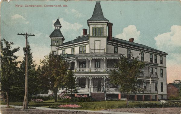 View from street of the ornate three-story Hotel Cumberland. Caption reads: "Hotel Cumberland, Cumberland, Wis."