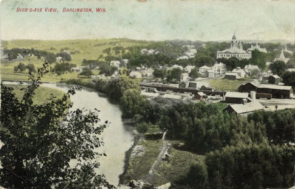 Aerial view along river toward Darlington. Caption reads: "Bird's-Eye View, Darlington, Wis."