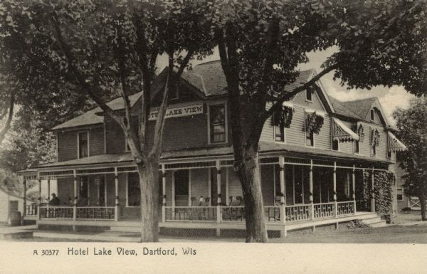 Photographic postcard of the Hotel Lake View at Dartford. It was built in 1891 by Henry Oelke and located at the corner of Hill and Gold Streets. It is no longer in existence. Caption reads: "Hotel Lake View, Dartford, Wis."