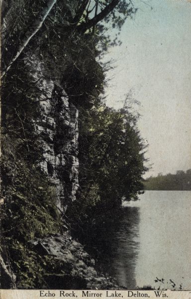 View along shoreline towards Echo Rock on Mirror Lake. Caption reads: "Echo Rock, Mirror Lake, Delton, Wis."