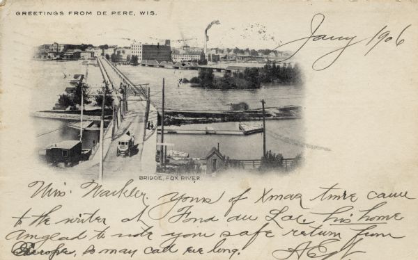 Elevated view of a wagon crossing the bridge over the Fox River at De Pere. Caption reads: "Greetings from De Pere, Wis." and "Bridge, Fox River."