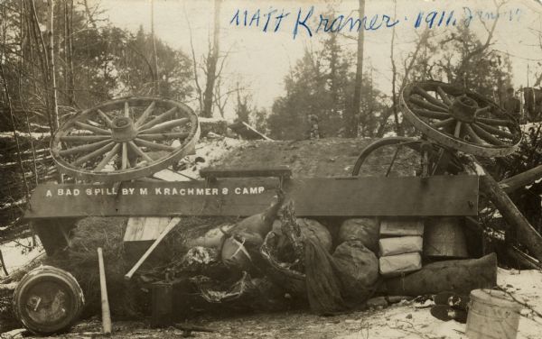View of an overturned delivery wagon near M. Krachmer's camp, five miles north of Antigo. Caption reads: "A Bad Spill By M. Krachner's."