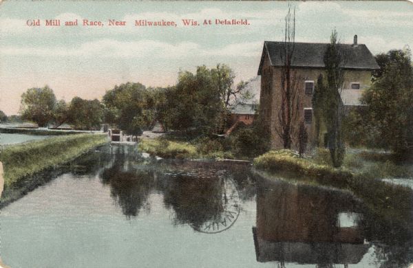 Colored postcard view of the old mill, stream and a dam. Caption reads: "Old Mill and Race, Near Milwaukee, Wis. At Delafield."