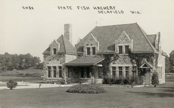 Photographic postcard of the state fish hatchery. Caption reads: "State Fish Hatchery, Delafield, Wis."