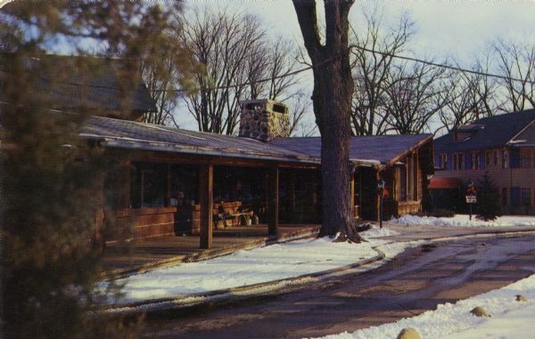 Photographic postcard of a winter scene of the front drive at Lake Lawn Lodge.