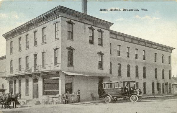 View from street looking towards the Hotel Higbee. There is a horse-drawn carriage on the left side, and a large, motorized vehicle, perhaps a bus, parked in front. Caption reads: "Hotel Higbee, Dodgeville, Wis."