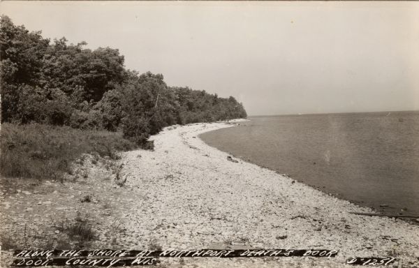 Black and white photographic postcard view along the shoreline of Lake Michigan at Northport.
