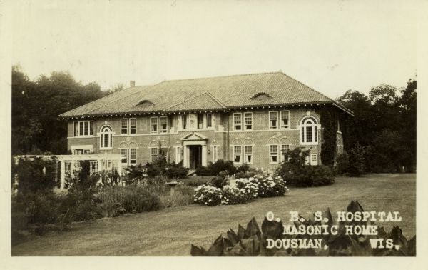 View across lawn towards the Order of Eastern Star hospital at the Wisconsin Masonic Home and Farm. Caption reads: "O.E.S. Hospital, Masonic Home, Dousman, Wis."