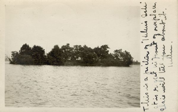 Photographic postcard view of "Helen's Isle" in a lake.
