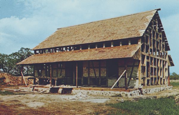 Color photographic postcard of the Koepsel house being reassembled at Old World Wisconsin near Eagle. It is an 1860's half-timber farmhouse that was built by an immigrant from Pomerania. The house was donated to the Wisconsin Historical Society by Otto Butt, Sr. and his son Elvin on August 12, 1969.  It was then moved from Jackson Township in Washington County.