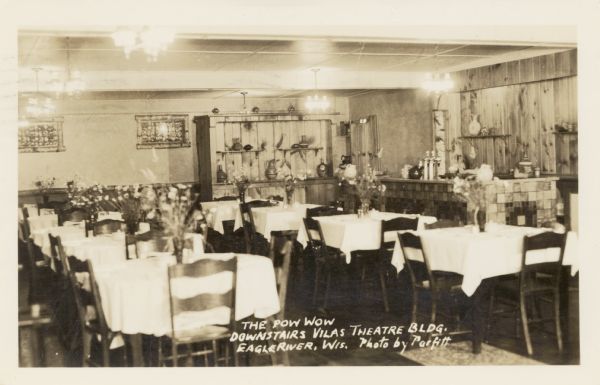 Interior view of the Pow Wow restaurant in the basement of the Vilas Theatre building at 214 East Wall Street. Caption reads: "The Pow Wow, Downstairs Vilas Theatre Bldg., Eagle River, Wis."