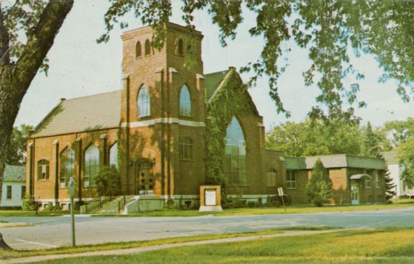View across sidewalk and street towards the First Congregational Church, located at the corner of First and Division Streets. Built in 1924.