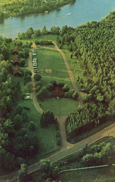 Aerial view of the Trees for Tomorrow Environmental Center, with buildings, grounds, roads, and the Eagle River. Founded in 1944.