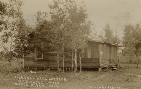 View of a cottage at the resort, northwest of Eagle River on CTH G. Caption reads: "Pickerel Lake Cottage, Wm J. Radue — Prop. Eagle River, Wis."