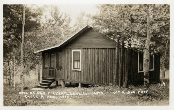 Cottage at the resort, northwest of Eagle River on CTH G. Captions read: "One of the Pickerel Lake Cottages, Eagle Lake, Wis." and "Wm J. Radue — Prop."