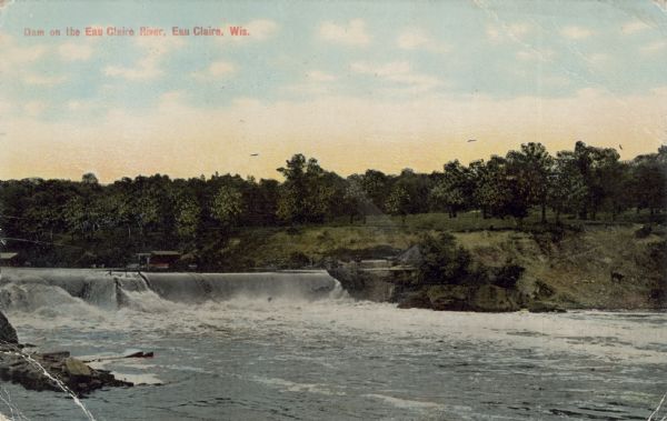 Colorized photograph of a dam on the Eau Claire River, Eau Claire, Wisconsin. Caption reads: "Dam on the Eau Claire River, Eau Claire, Wis."