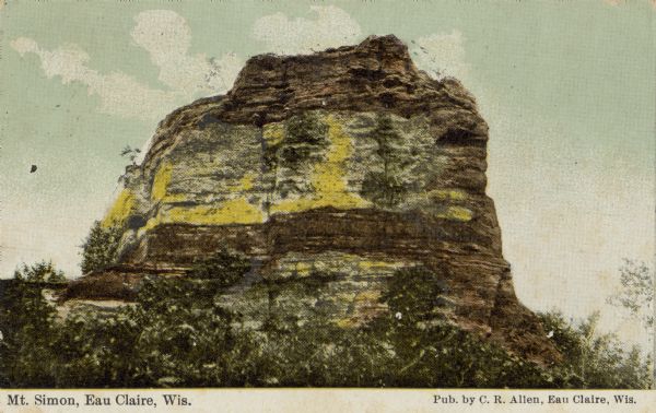View of the front of Mt. Simon, a sandstone bluff. Caption reads: "Mt. Simon, Eau Claire, Wis."