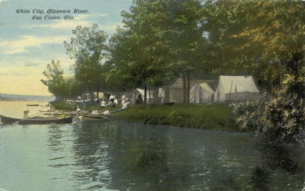 View along shoreline towards White City, a group of white camping tents, pitched along the Chippewa River. People are in boats near the shoreline. Caption reads: "White City, Chippewa River, Eau Claire, Wis."