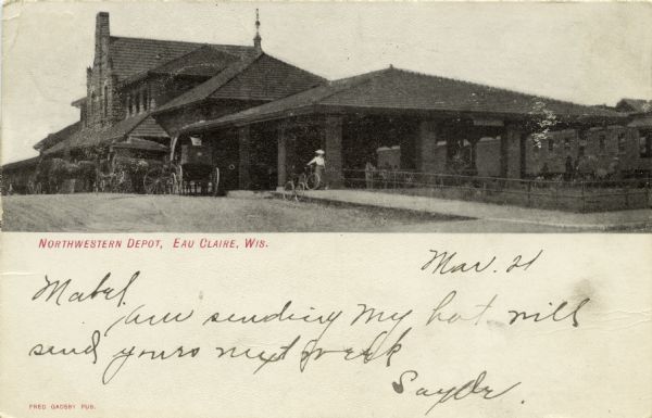 Black and white photographic postcard view of the Northwestern depot, with horse-drawn carriages and bicycles. Caption reads: "Northwestern Depot, Eau Claire, Wis."