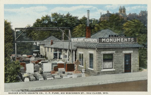 Colorized photograph of the Badger Granite Compnay, maker of monuments and gravestones. There is a church in the background. Caption reads: "Badger State Granite Co., C. F. Funk, 418 Wisconsin St., Eau Claire, Wis."