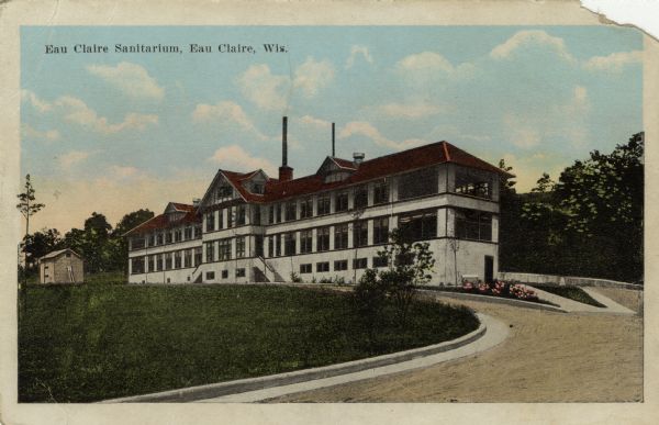 Colorized photographic postcard view of the sanitarium. Caption reads: "Eau Claire Sanitarium, Eau Claire, Wis."