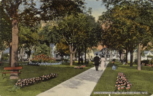 Colorized photographic postcard view of University Park. A couple is strolling down the sidewalk. Caption reads: "University Park, Eau Claire, Wis."