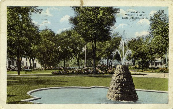 Colorized photograph of the fountain in Wilson Park. Caption reads: "Fountain in Wilson Park, Eau Claire, Wis."