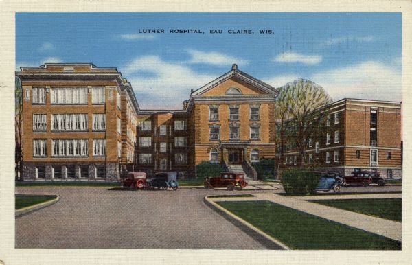 Colorized photographic postcard view of the front of Luther Hospital with automobiles parked in the drive. Caption reads: "Luther Hospital, Eau Claire, Wis."