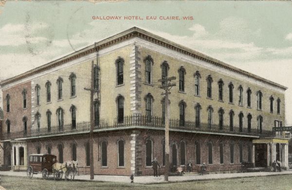View from intersection towards the Galloway Hotel, a large three story building with wrought iron fencing along the second story. People are sitting in front of the hotel on the right. On the left is a horse-drawn bus. Caption reads: "Galloway Hotel, Eau Claire, Wis."