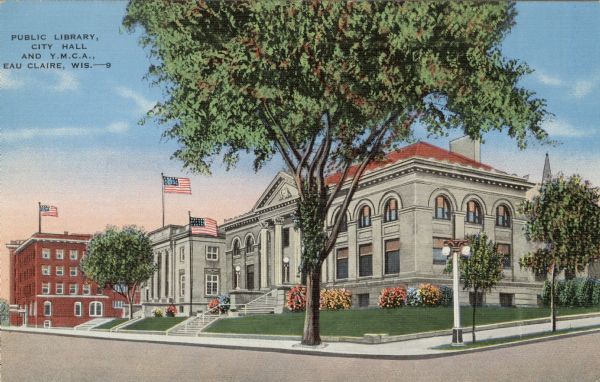 Postcard view from street towards the city block containing the public library, the courthouse and the Y.M.C.A. Flags are flying on flagpoles in front of each building. Caption reads: "Public Library, City Hall, and Y.M.C.A., Eau Claire, Wis."