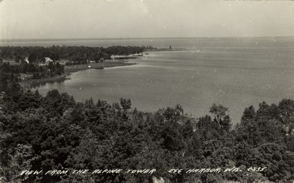 Elevated view of Green Bay from the Alpine Tower at Egg Harbor. A few dwellings are along the shoreline on the left. Caption reads: "View from the Alpine Tower, Egg Harbor, Wis."