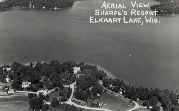 Aerial view of a resort on the shore of Elkhart Lake. Caption reads: "Aerial View Sharpe's Resort, Elkhart Lake, Wis."