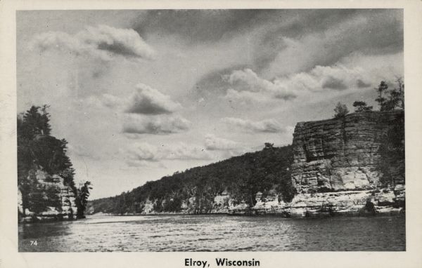 View of the Baraboo River and the rock formations on both sides. Caption reads: "Elroy, Wis."