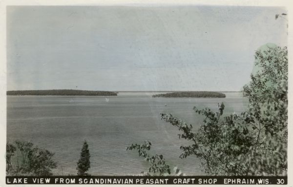 Elevated view of Green Bay from Ephraim. There is an island in the bay. Caption reads: "Lake View from Scandinavian Peasant Craft Shop, Ephraim, Wis."